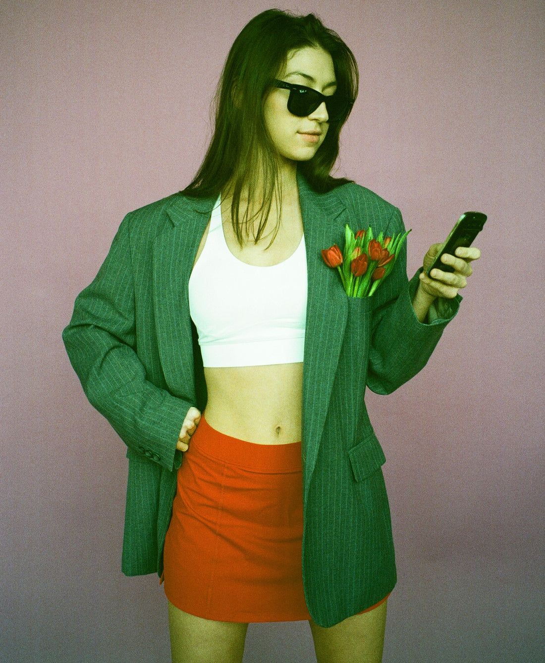Wear One's At Simple Skort in scarlet on model wearing suit coat looking at a phone
