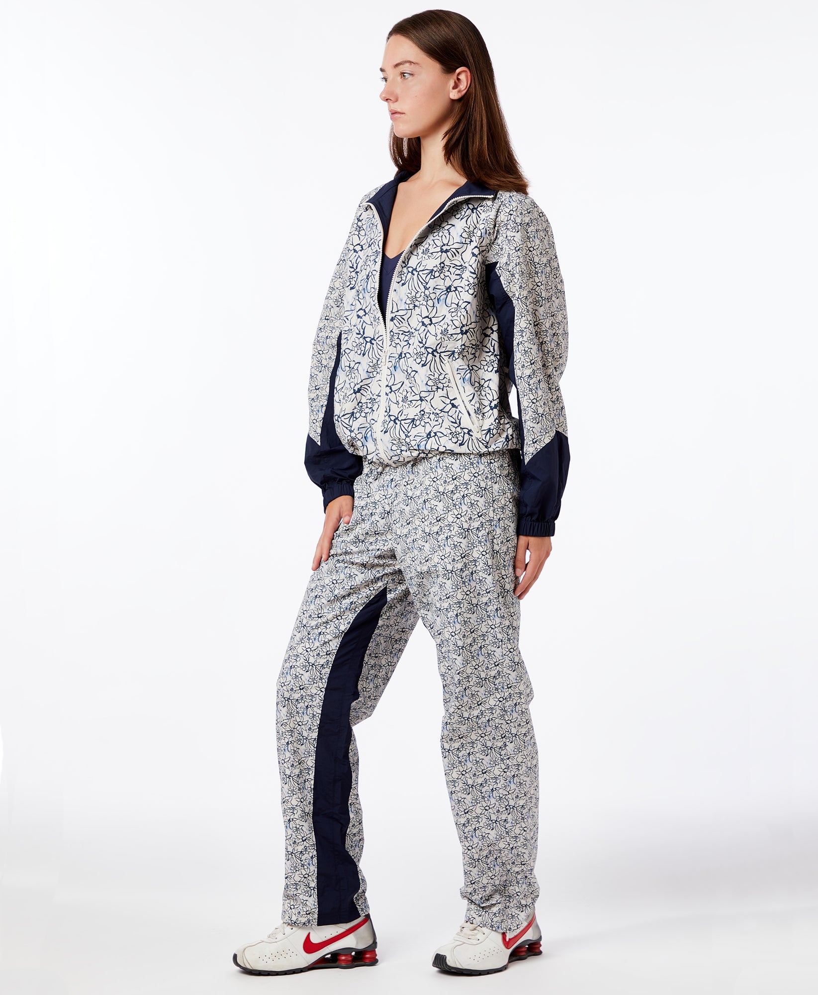 Wear One's At Alpine Pant in Navy Ink Flower on model with leg forward side view