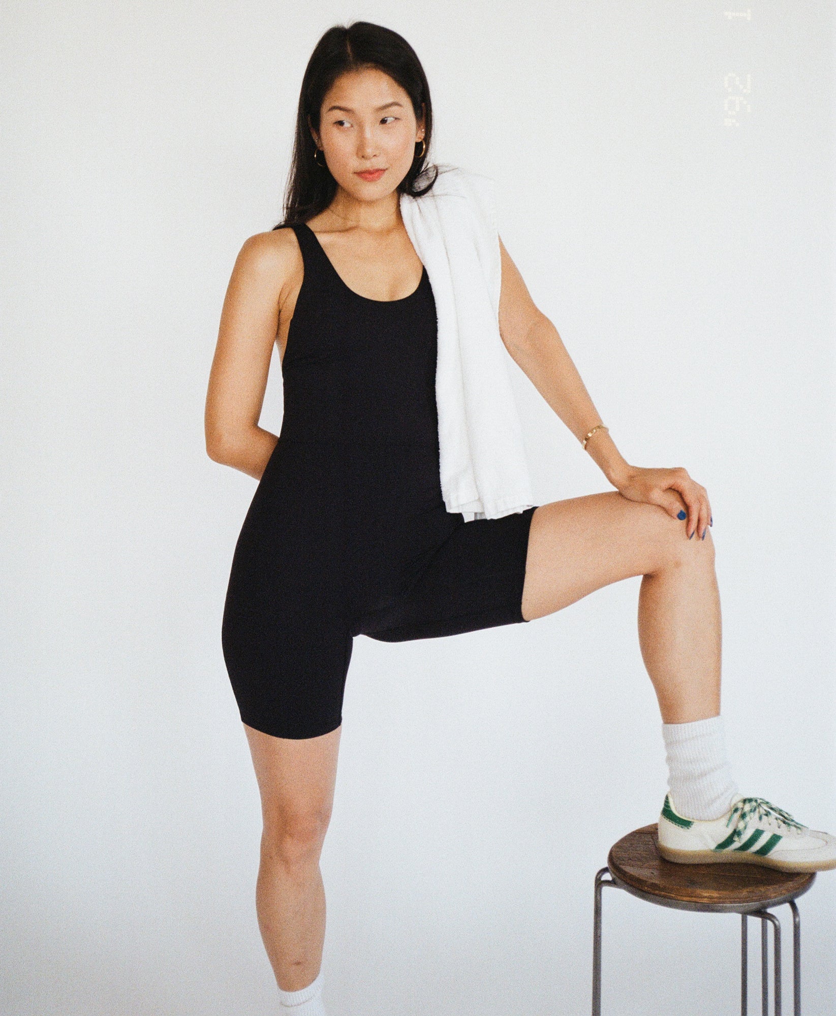 Wear One's At Bike Short Unitard in bean on model with left foot on a stool