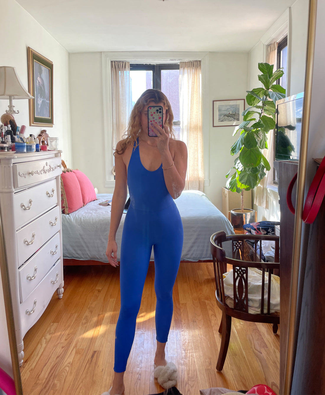 Wear One's At Liberty Unitard in royal Blue on model standing in front of mirror