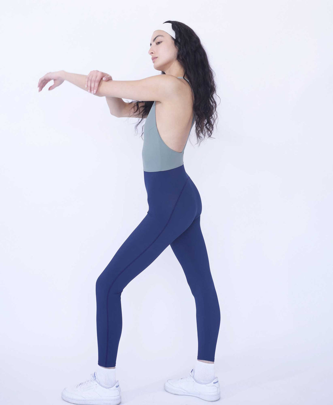 Wear One's At Liberty Unitard in Sage and Navy on Model with Arm Out Full Side View