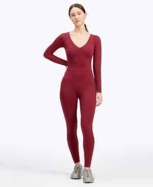 Wear One's At Long Sleeve Varsity Unitard in pomegranate on model with hand on hip full front view