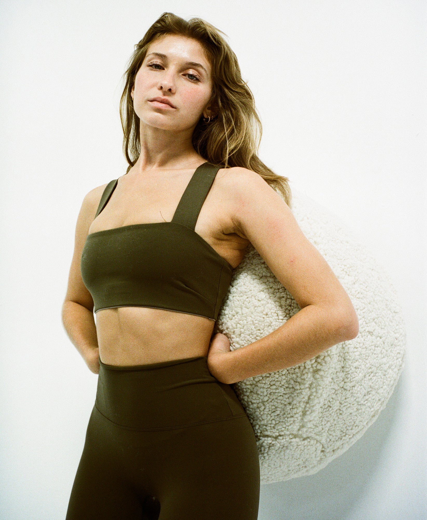 Wear One's At Routine Legging in canteen on model leaning against ball