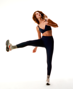 Wear One's At Routine Legging in Navy on model kicking leg out full front view