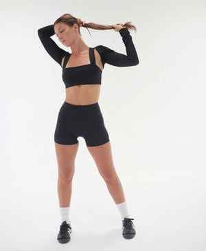 Wear One's At The Scrunch Shrug in Goji Black on model standing full front view