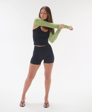 Wear One's At The Scrunch Shrug in Kiwi Green on model stretching full front view