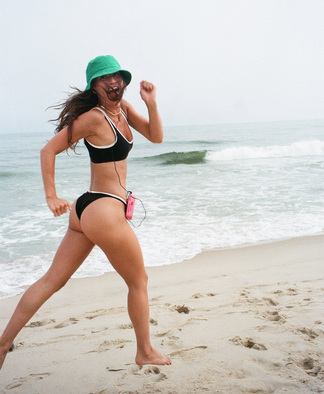Wear One's At Ditch Plains Bikini Top in Black Essex on Model Running on the Beach Side View