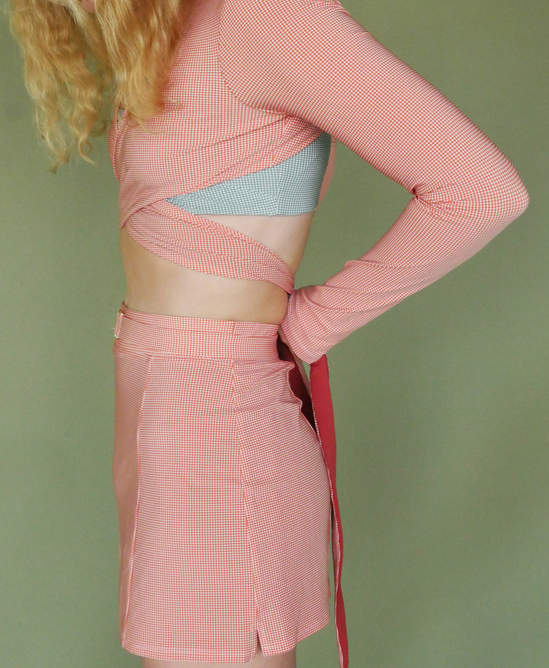 Wear One's At Simple Skort in Meadow Orange on Model Tying Ties Side View