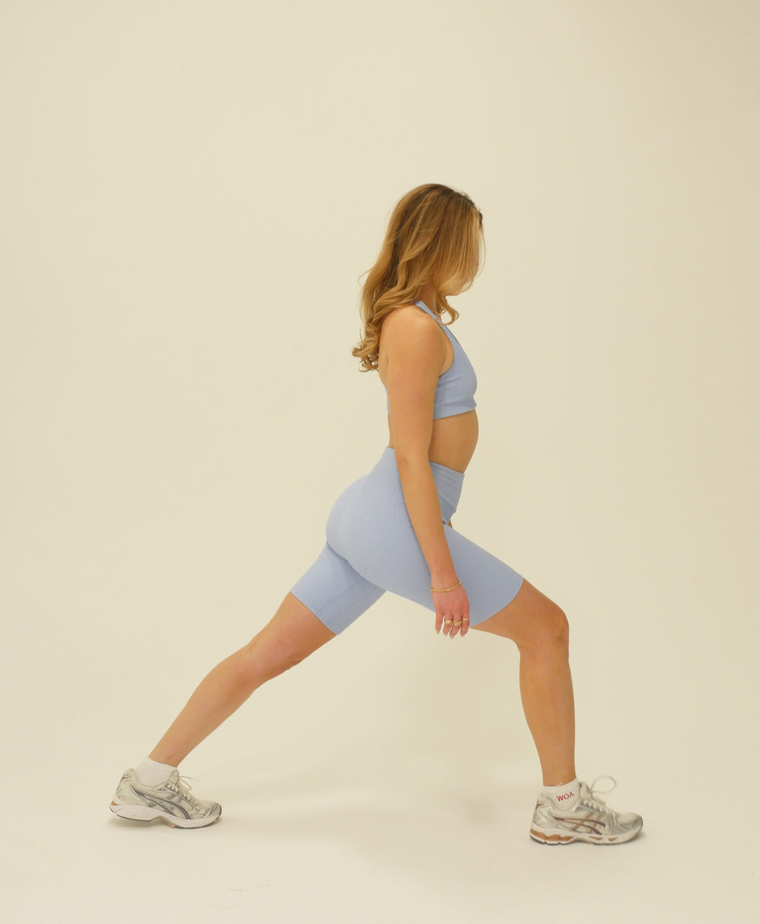 Wear One's At Tech Wave Bike Shorts in In Your Dreams Light Blue on Model Lunging Side View